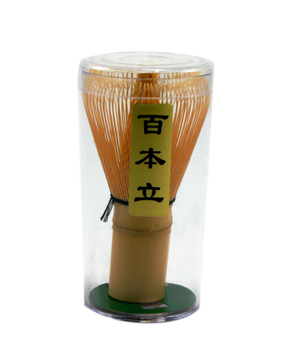 A bamboo Chasen Matcha Whisk in a clear plastic case, featuring fine, hand-carved prongs for frothing matcha tea. Traditional Japanese matcha preparation tool.