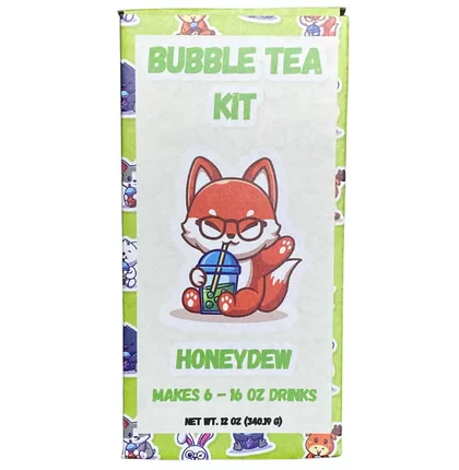 A green box labeled Honeydew Bubble Tea Kit with a cartoon fox wearing glasses drinking boba. Includes ingredients to make six 16 oz honeydew bubble tea drinks.