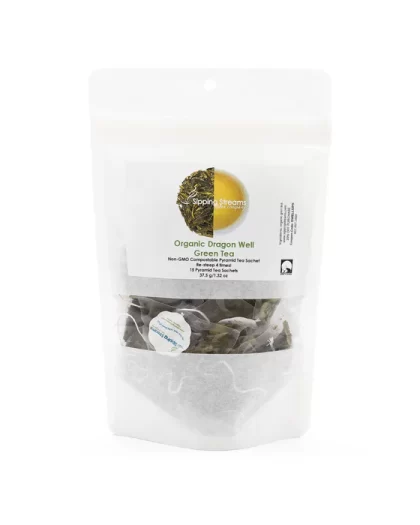 A clear, resealable bag containing 15 pyramid sachets of Sipping Streams Tea Company's Dragon Well Green Tea. The label showcases the natural green tea blend and promotes the non-GMO, compostable packaging, along with the re-steepable feature for a refreshing tea experience.