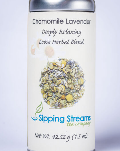 A tall retail tin filled with Chamomile Lavender herbal tea, featuring whole chamomile blossoms and aromatic lavender for a soothing infusion.