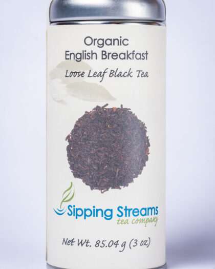 A tall retail tin filled with Organic English Breakfast loose leaf black tea, offering a rich, robust flavor perfect for morning or all-day enjoyment.