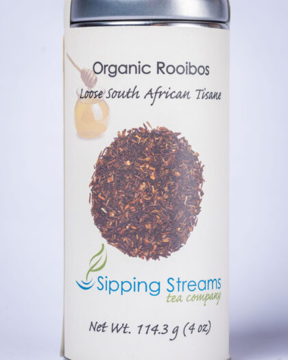 A tall retail tin filled with Organic Rooibos loose leaf herbal tea, featuring fine rooibos needles known for their smooth, naturally sweet flavor.