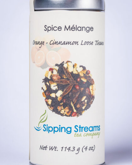 A tall retail tin filled with Spice Melange, a fragrant blend of organic black tea, orange peel, cinnamon, and warming spices.